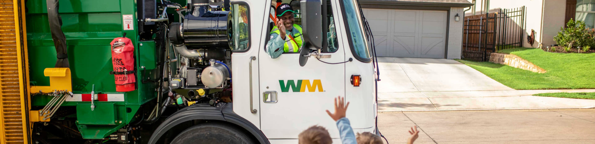 Kids wave to WM truck passing by in residential area