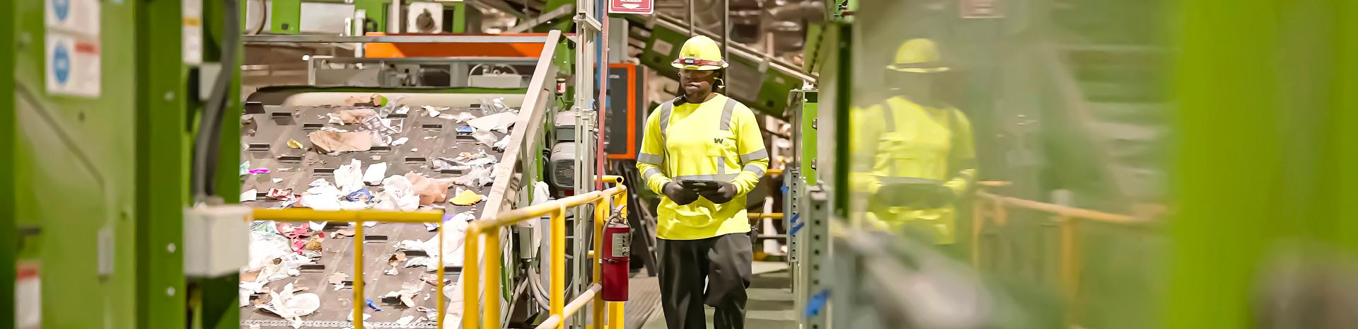 Image of recycling facility shows paper material moving on belt