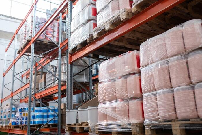 Stretch wrapped canisters on pallets in warehouse